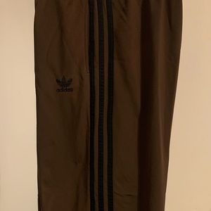 Mens brown and black size Xsmall polyester track pants.